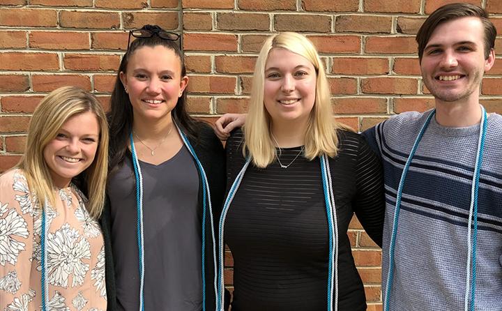 Photo of students with graduation cords